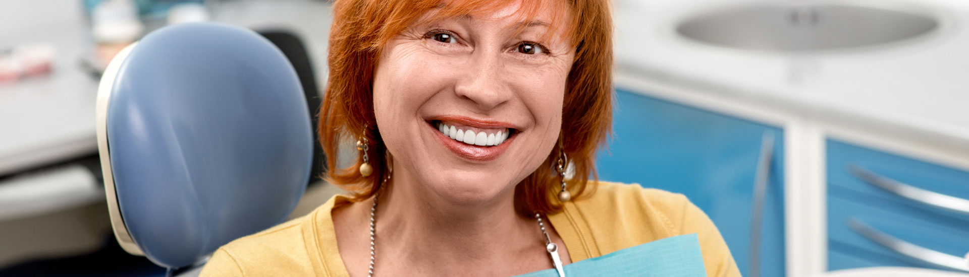 Happy woman after having dental implant treatment